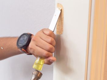 Contractor performing a door frame repair at a home in Twin Lakes, WI